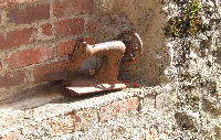 Posed sewing machine in a ruined house in Oradour