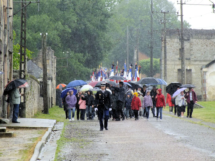 Procession along the Rue Emil Desourteaux towards the old church in Oradour-sur-Glane