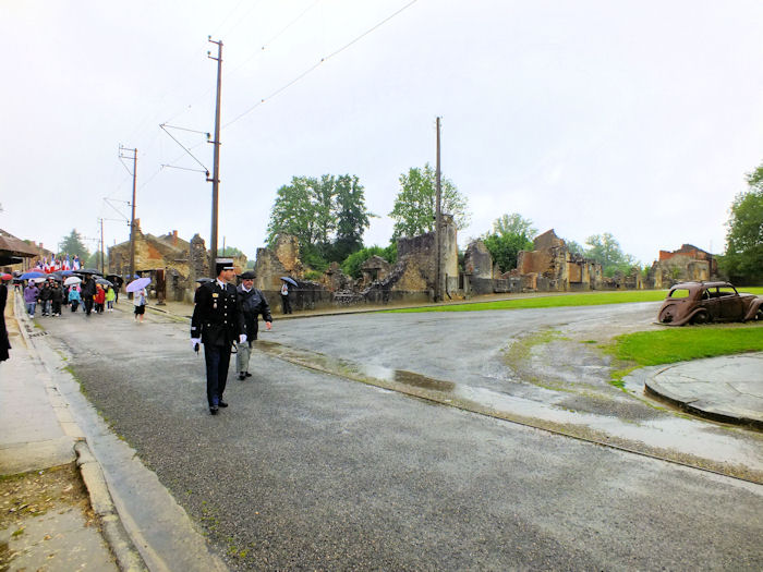 Procession passing the Doctor's car in Oradour-sur-Glane