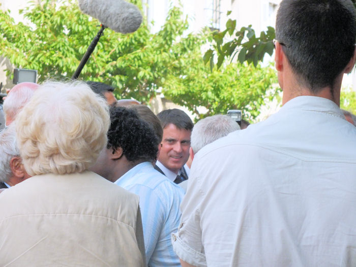 The Prime Minister Manuel Valls in front of the Post Office of Oradour new town in 2014