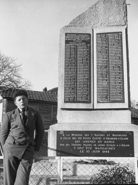 Roger Godfrin by memorial to teachers and schoolchildren